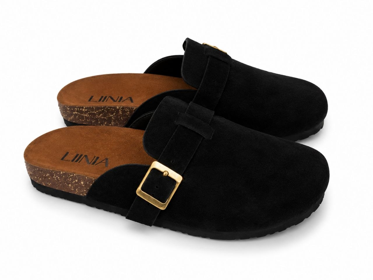 A pair of black suede clogs with a gold buckle strap and a cork-look sole, shown on a clean white background.