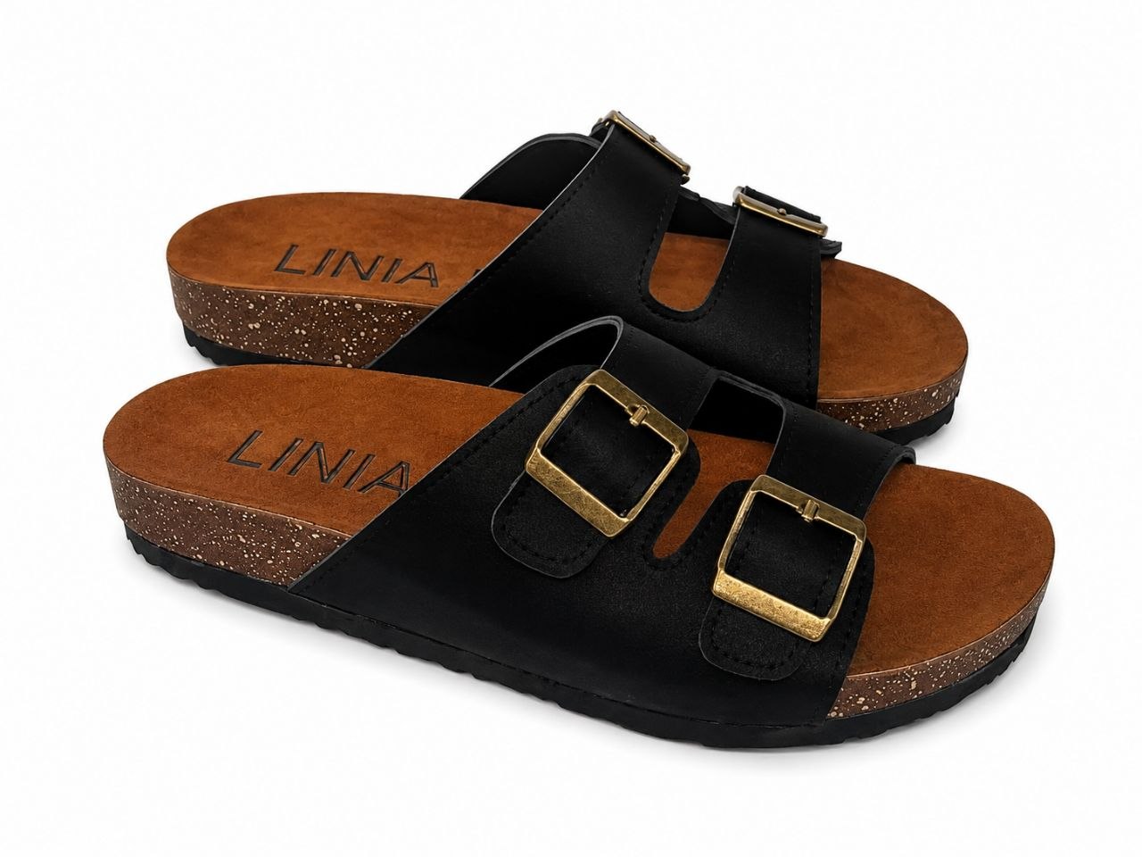 A pair of black double-strap slide sandals with gold-tone buckle details and a brown cork-textured footbed, shown on a plain white background.