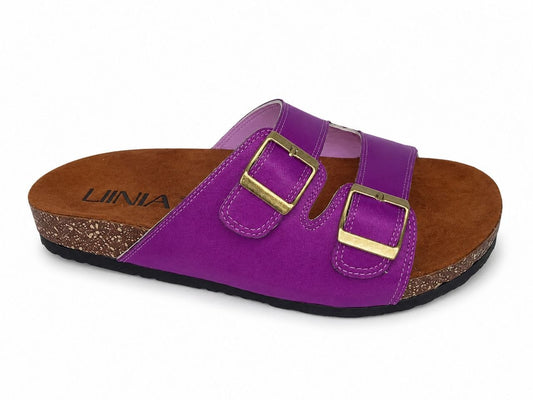 A single purple double-strap sandal with gold-tone buckles, a brown cork-textured footbed, and a black outsole, shown on a white background. The brand name 'LINIA' is visible on the footbed.