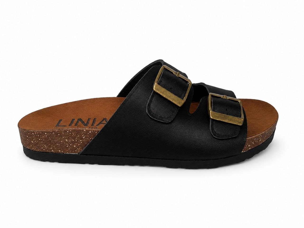 A black double-strap slide sandal with gold-tone buckle details, a brown cork-textured footbed, and a black sole, shown from a side profile on a white background.